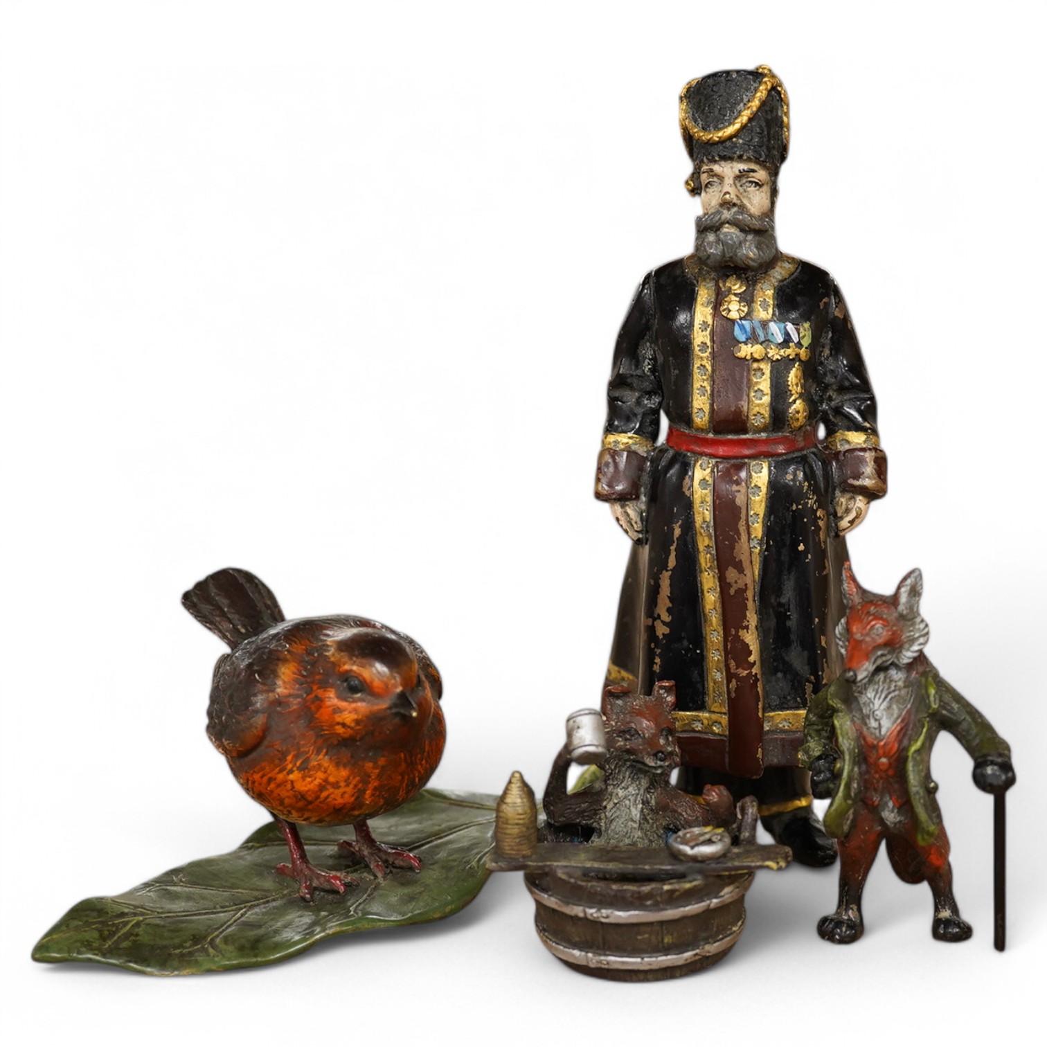 Three Austrian cold painted bronzes together with a Russian example of a gentleman in military dress, largest 18cm high. Condition - good